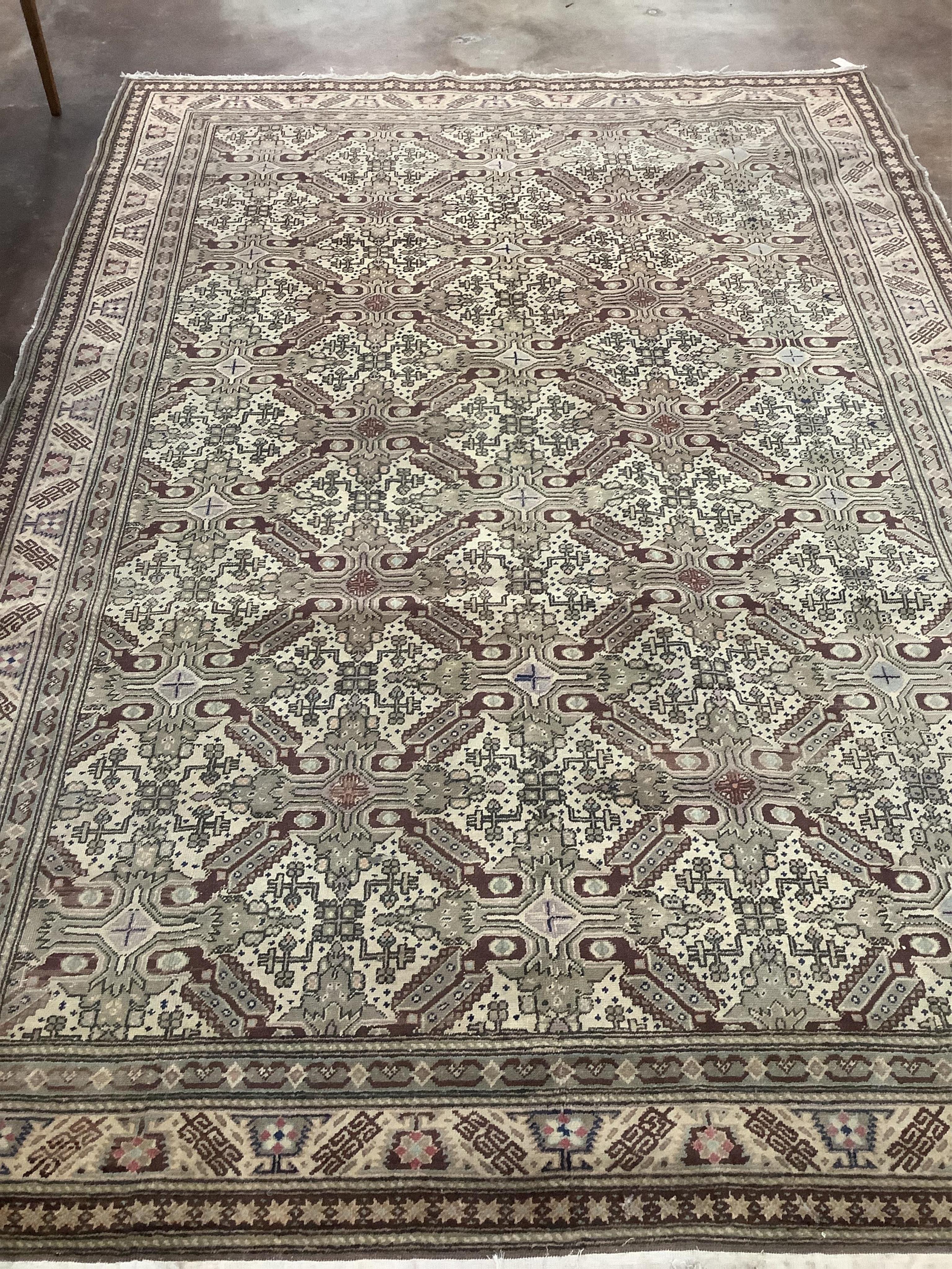 An ivory ground geometric carpet, approx. 290 x 200cm. Condition - fair